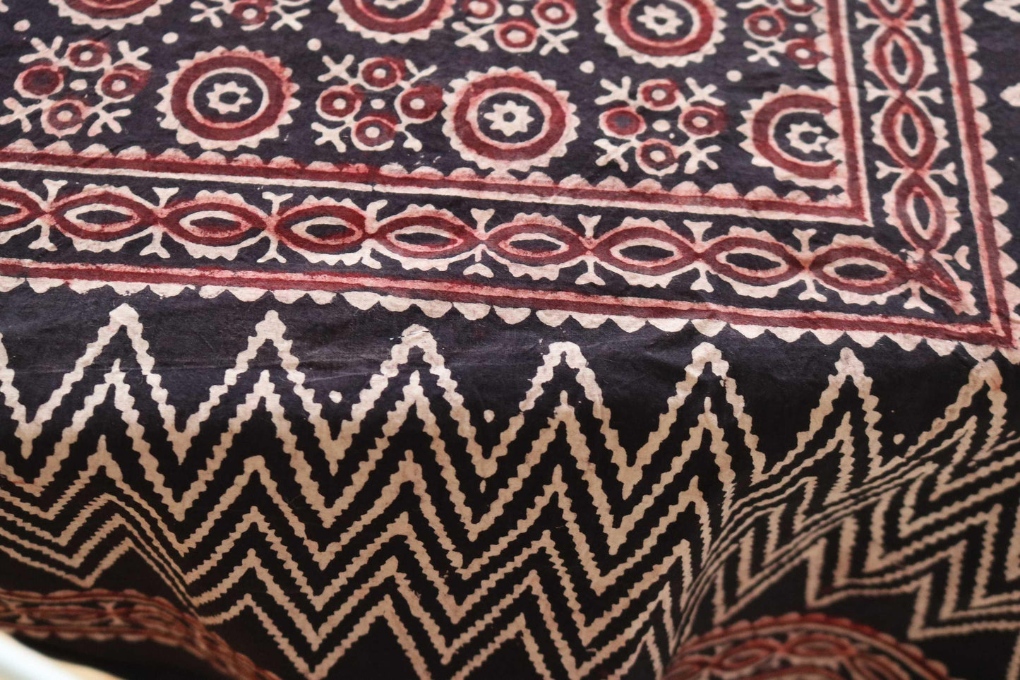 Black and maroon hand-dyed block print table cover with 8 matching napkins featuring chevron, floral, and check patterns - an eco-friendly and ethically made dining ensemble by Ethimaart.