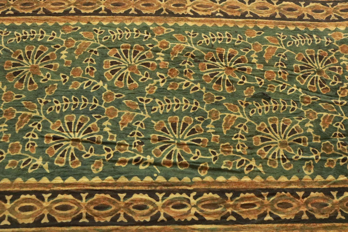 Green and saffron hand-dyed block print table cover with 8 matching napkins showcasing fish and floral patterns - an eco-friendly and ethically made dining ensemble by Ethimaart.