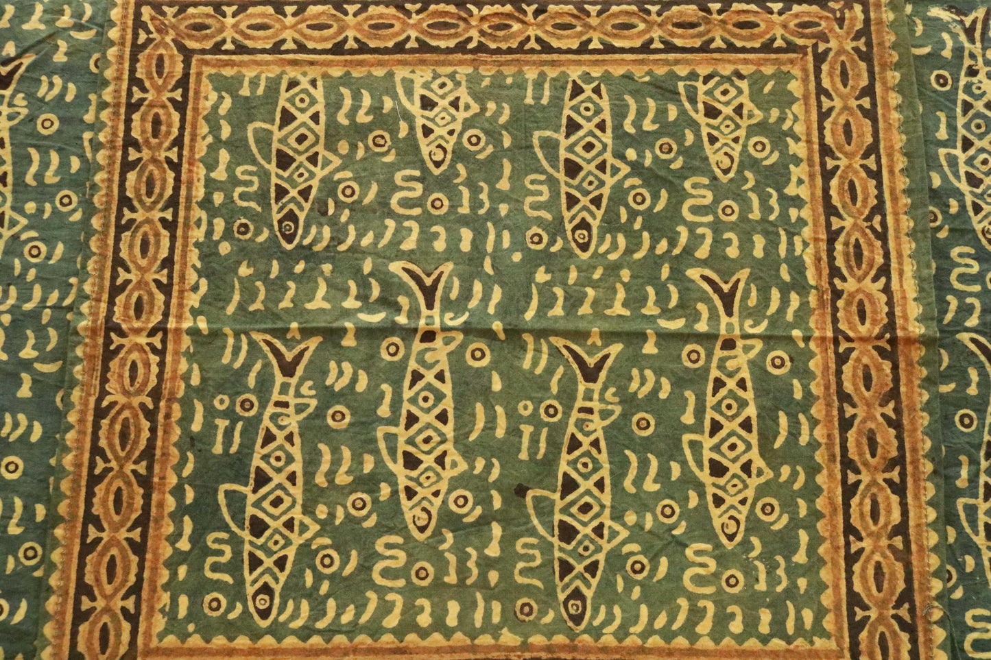 Green and saffron hand-dyed block print table cover with 8 matching napkins showcasing fish and floral patterns - an eco-friendly and ethically made dining ensemble by Ethimaart.