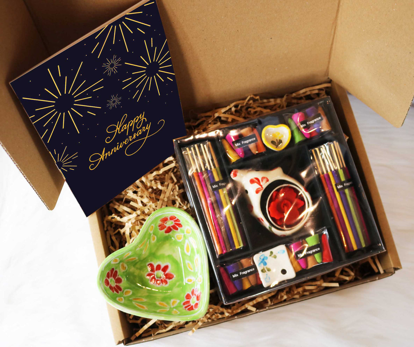 Employee Work Anniversary Gift | Ethical Corporate Hampers hand crafted in thailand and india by skilled artisans. This hamper includes luxurious incense gift hamper with mixed incense cones and sticks, tea light elephant ceramic holder and a heart holder. Also a ceramic heart trinket dish and anniversary card.