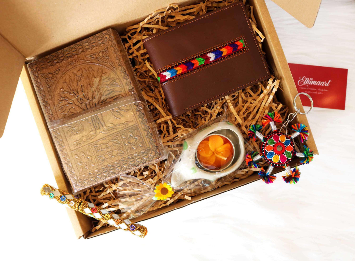Discover a collection of unique, ethically sourced gift boxes like this Men's Eco Friendly Hamper! Crafted with sustainability in mind, it features a handcrafted leather wallet, travel journal, and more. Empower artisans, promote eco-consciousness. Shop Ethimaart for corporate gifting solutions.
