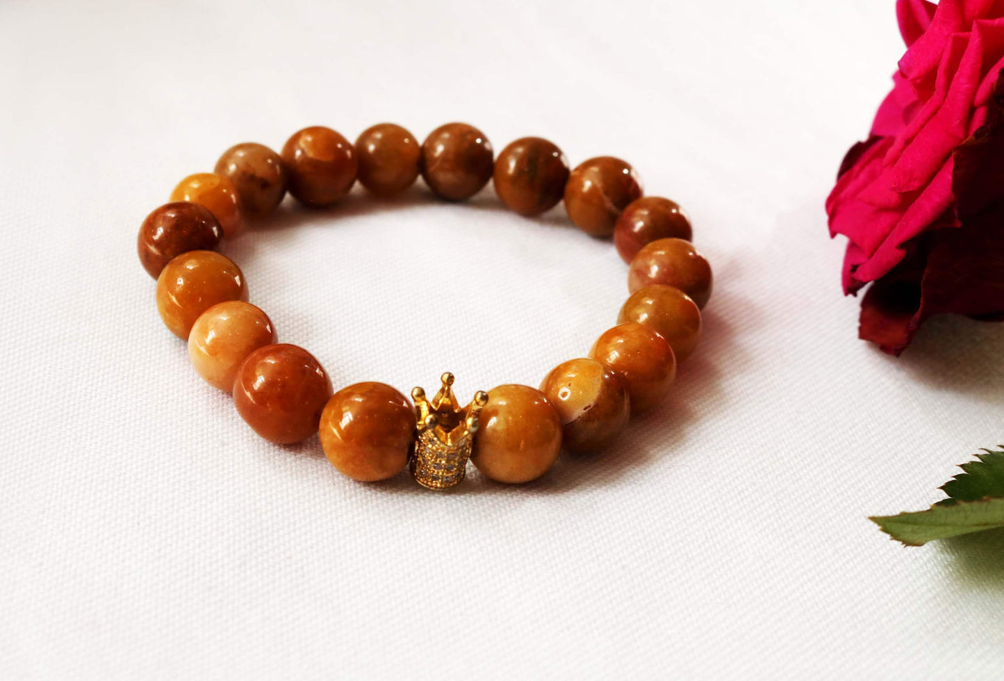 Beaded Bracelet Explore our exquisite gemstone collection, perfect for gifting on any occasion. Our Men's Mustard Gemstone Bracelet, featuring a regal crown design, is crafted with genuine mustard gemstones for a touch of sophistication. Treat him to timeless elegance. Shop now at Ethimaart.
