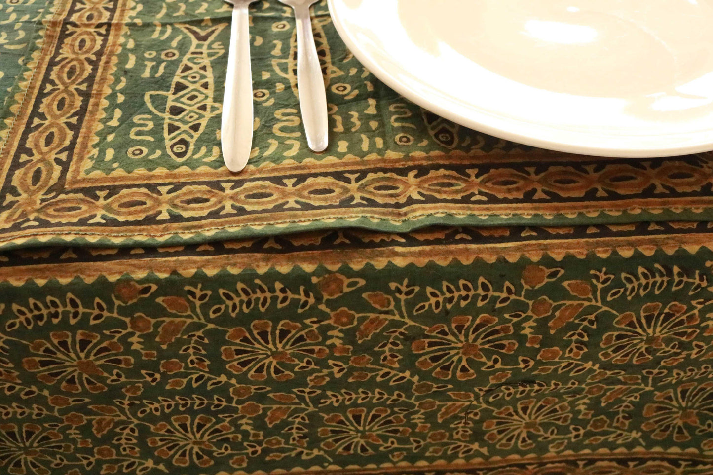 Green and saffron hand-dyed block print table cover with 8 matching napkins showcasing fish and floral patterns - an eco-friendly and ethically made dining ensemble by Ethimaart.