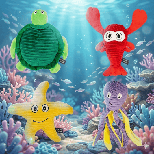 Four plush toys shaped like a turtle, lobster, starfish, and octopus in an underwater scene with coral and fish. Ocean Animal Squeaky Dog Toy - Soft Interactive Plush