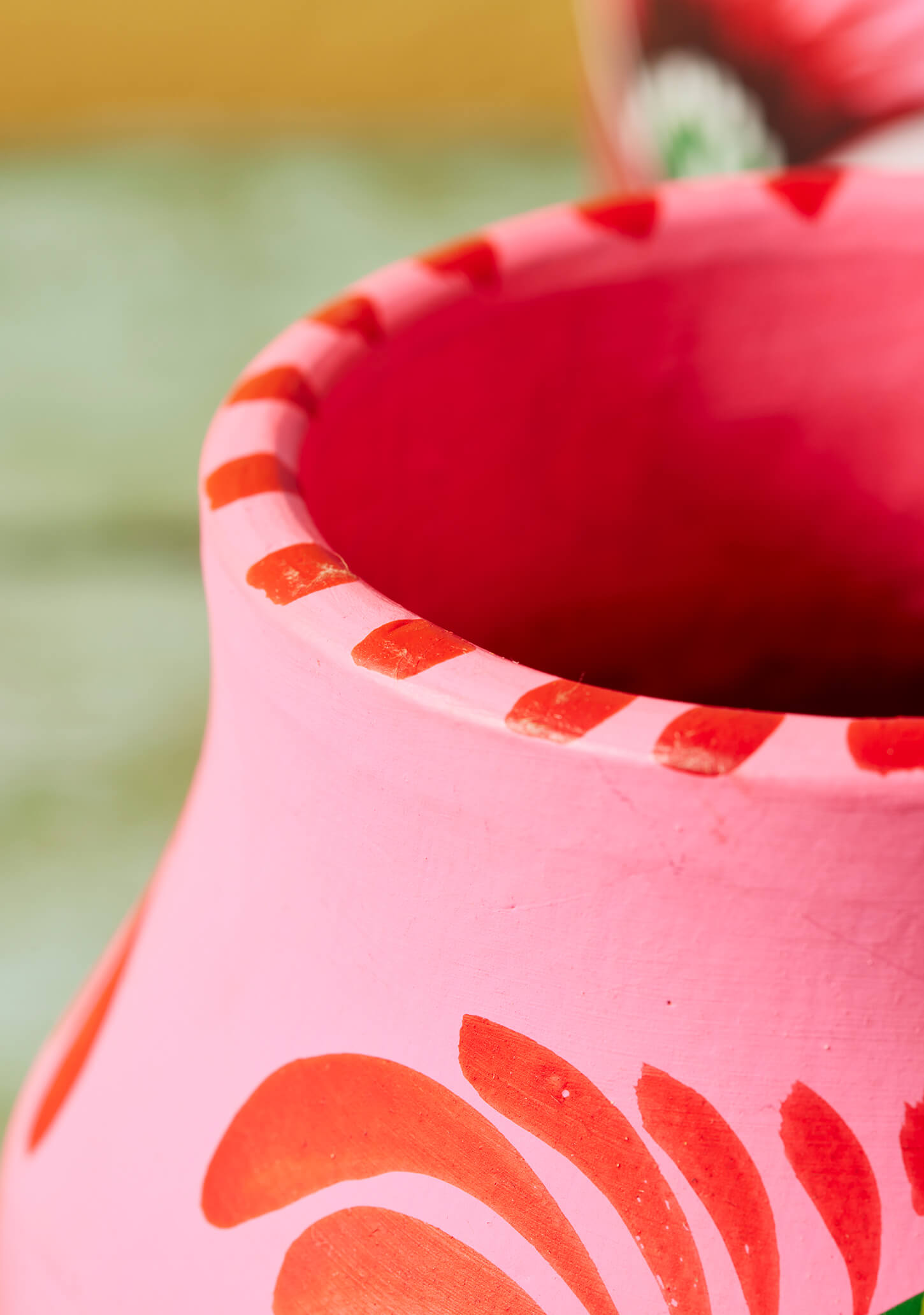 Eco-friendly terracotta flower pot with vibrant pink hand-painted artwork