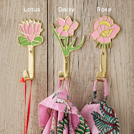 Decorative flower hooks with 'Lotus', 'Daisy', and 'Rose' labels on a wooden background.