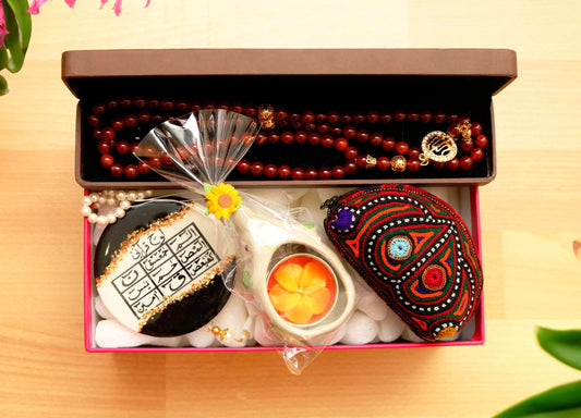 Ethically sourced, handcrafted Ramadan gifts! This hamper features Aqeeq tasbeeh, resin dua car hanging with Lohe Qurani, embroidered purse, & elephant tealight holder. Perfect for colleagues or loved ones.
